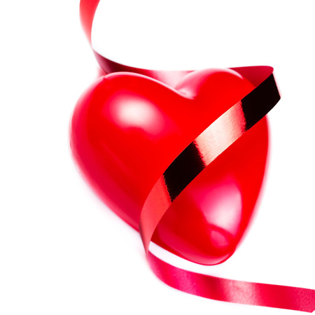 Big Red Heart with festive red ribbon isolated on white background, close up. Love  Love Beautiful concept. Valentines Day card. の写真素材