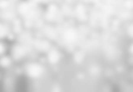 Abstract Christmas De focused Background with Blurred Bokeh texture and festive white and silver lightsの写真素材