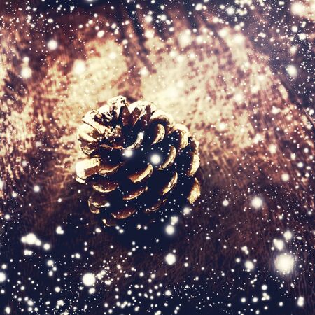 Christmas background with christmas decoration. Festive pine cone over wooden board.の写真素材
