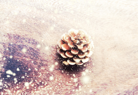 Christmas decoration with pine cone on wooden background. Christmas card