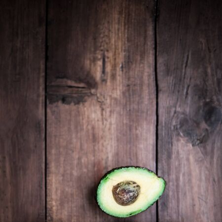Food background with green  organic avocado on old wooden table. Top view image with  copy spaceの写真素材