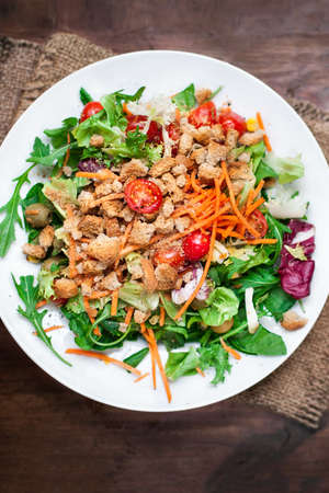 Healthy Salad with arugula, tomatoes and  Croutons. Vegetable salad. Healthy eating, dieting, vegetarian kitchenの写真素材