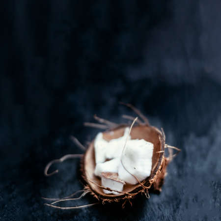 White Coconut pieces over black backgroundの写真素材