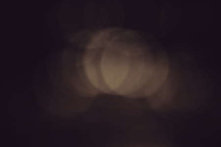Defocused bokeh lights on black background / night lightsの写真素材