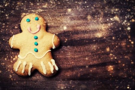 Christmas homemade gingerbread man cookie on wooden table. Christmas Holiday Background.の写真素材