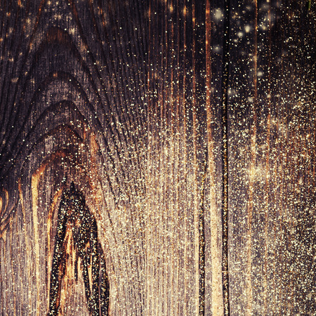Wooden textured background with golden glitter. Wood Christmas  background with copyspaceの写真素材