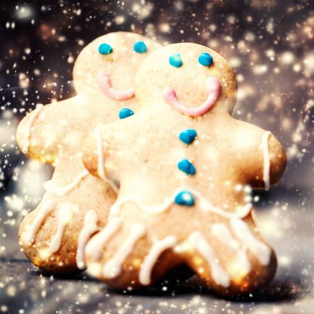 Christmas homemade gingerbread cookies over wooden table. Christmas Card