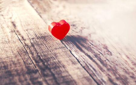 Valentines Day background with red heart on old wooden board  with copy space.  Holidays card.