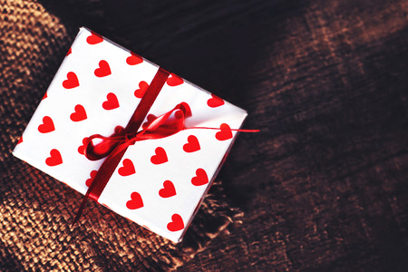 Valentines Day Card  background with white  gift box with red heart 