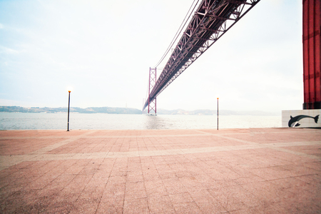 LISBON, PORTUGAL - October 21, 2016: The 25 de Abril bridge over Tagus river and Christ monument in Lisbon, Portugal with wide angle viewのeditorial素材