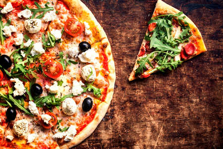 Fresh baked Hot pizza slice with cheese on a rustic wooden table  closeup
の写真素材
