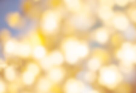 Golden Christmas background with natural  bokeh and twinkled defocused lights. Festive blur...
