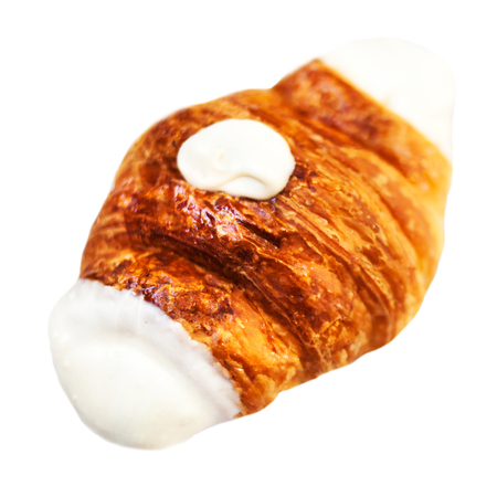 Fresh croissant decorated  with white chocolate isolated on a white background closeupの写真素材