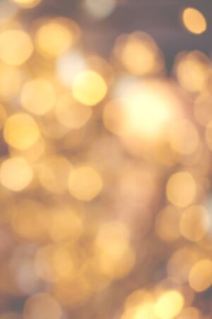 Golden Christmas background with natural  bokeh and twinkled defocused lights. Festive blur background の写真素材