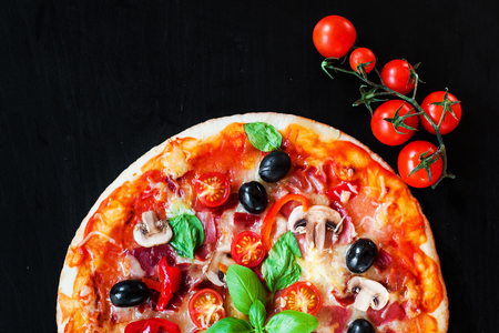 Delicious Vegetable Vegetarian Pizza on dark background just from oven. Top view with free space for text.の写真素材