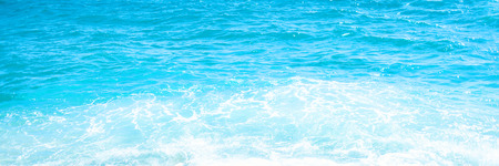 Soft wave of blue ocean on sandy beach Background with place for text. Tropical summer vacation concept.の写真素材