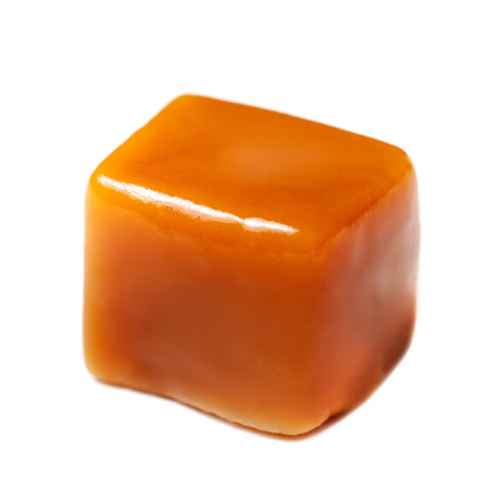 Brown Caramel candy isolated on white background.  Piece of caramel Butterscotch toffee, macroの写真素材