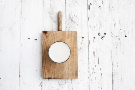 Glads of milk  on rustic white wooden table. Healthy breakfast, morning concept, copy spaceの写真素材