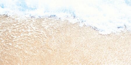 Soft wave of blue ocean on sandy beach Background with place for text. Tropical summer vacation...