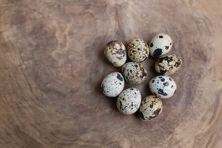 Quail eggs on wooden background with copy spaceの写真素材