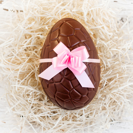 Chocolate Easter eggs on white wooden background. Top view with copy space
の写真素材