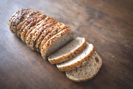 Top view of sliced wholegrain bread on dark ructic wooden  background closeup
の写真素材