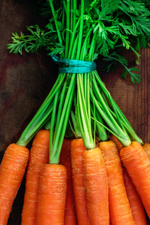 Fresh carrots bunch on rustic wooden background with copy space. Healthy  Detox conceptの写真素材