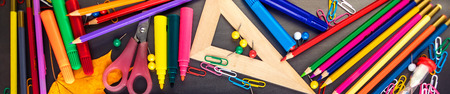 School supplies on black board background with Stationery. Back to school, office concept. Flat lay,...