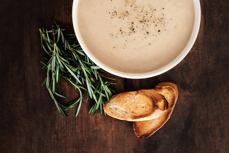 Creamy Mushroom Soup in a white bowl on rustic  wooden  table. . Top view. Copy spaceの写真素材