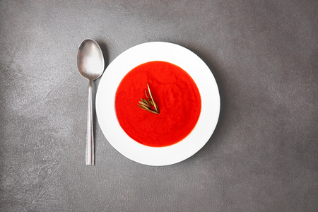 Vegetarian autumn  Tomato soup  on grey stone background. Top view. Copy spaceの写真素材