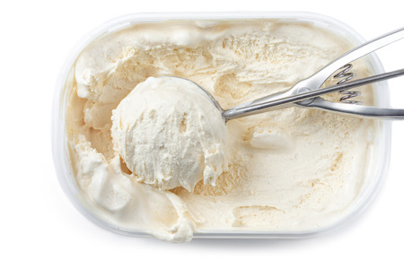 Vanilla ice cream with a scoop in  container isolated on white background. Scooped out ice-cream,  top view.の写真素材