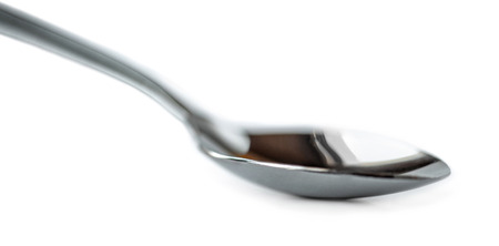 Spoon isolated on white background. Silver spoon Macro. Side viewの写真素材