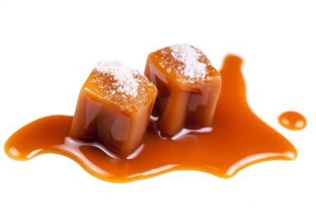 Melted caramel candies and caramel sauce with a salt  isolated on a white background. Close upの写真素材