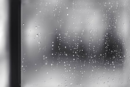 Rain water drops  on clear window.  Natural Pattern of raindrops. Autumn  depressive background.