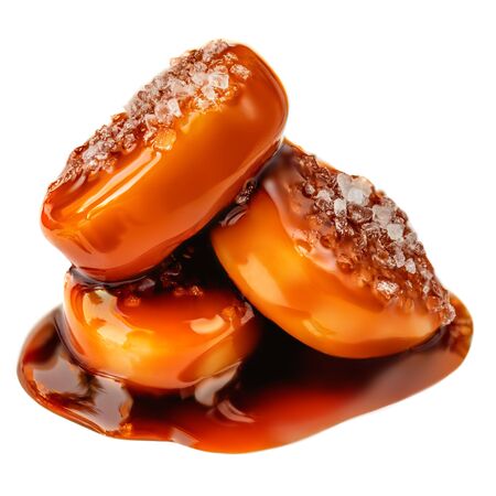 Toffee candy isolated.  Caramel candies with sauce isolated on white background close-upの写真素材
