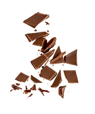 Falling Chocolate pieces and  shavings  isolated on white backgroundの写真素材