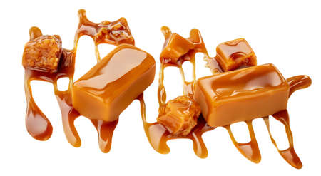 Ð¡aramel candies with caramel sauce isolated on a white background. Butterscotch Toffee candy collection, top viewの写真素材