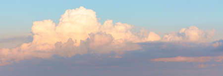 Gorgeous Panorama with blue sky and fluffy clouds at sunrise. Seascape background image