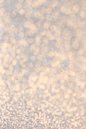 Christmas glowing Golden Background. Christmas lights. Blurred Xmas Bokeh as a Greeting cardの写真素材