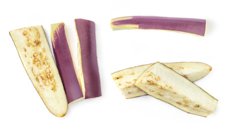 Creative layout made of Eggplant slices isolated on white background. Long Japanese Eggplant pieces top view. Flat layの写真素材