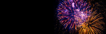 Holiday Fireworks at New Year Eve. Abstract Festive background with fireworks sparkles. Copyspace