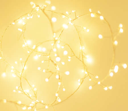 Christmas bright glowing Golden Abstract Background. Blurred Xmas Bokeh lightsの写真素材