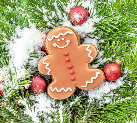 Christmas background with gingerbread man, fir branches and decorations as a background.の写真素材
