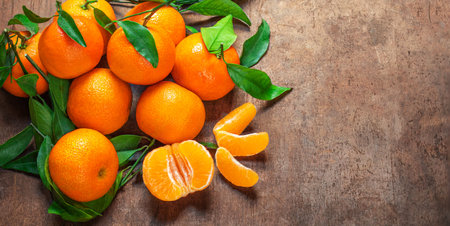 Mandarin oranges fruits or tangerines with leaves on a wooden table. Copyspace. Fresh picked mandarins Top view. Wallpaperの写真素材