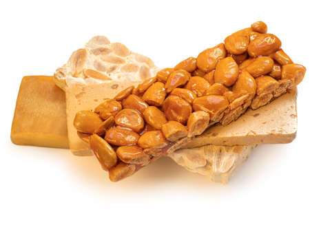 Turron nougat - traditional almond and caramel dessert isolated on white background. Christmas turron candyの写真素材