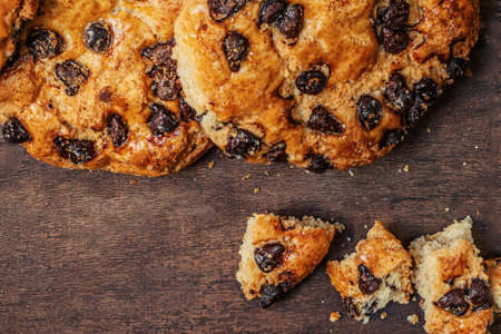 Chocolate cookies with crumbs on dark wooden table. Brown Chocolate chip cookies top viewの写真素材