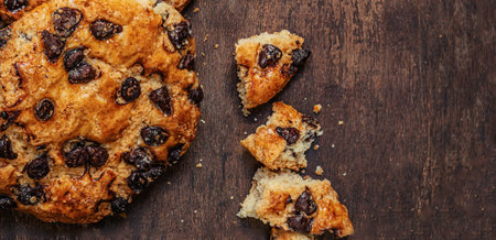 Chocolate cookies with crumbs on dark wooden background. Brown Chocolate chip cookies top viewの写真素材