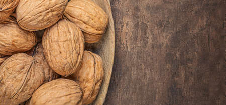 Walnut. Peeled walnut kernel nut on wooden background. Top view. Flat layの写真素材