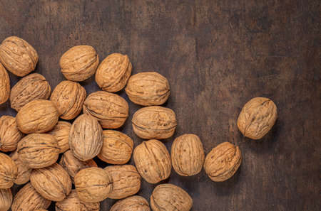 Walnut. Peeled walnut kernel nut on wooden background. Top view. Flat layの写真素材