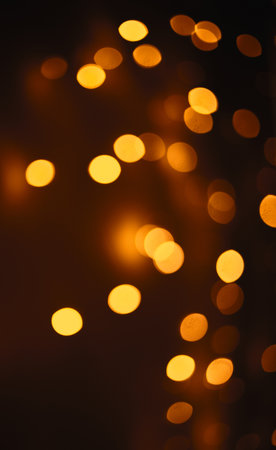 Christmas dark glowing Golden Abstract Background. Blurred Xmas Bokeh lightsの写真素材